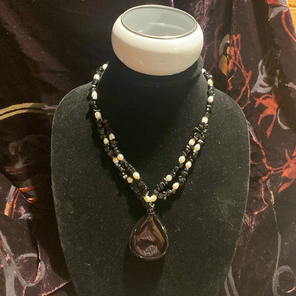 Black and white beaded Multi strand necklace with twist closure. Bracelet